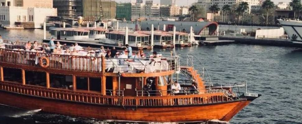 Luxurious yacht setting sail on a clear evening in Dubai.