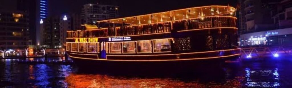 Aerial view of Dubai Marina at night with the dhow cruise.