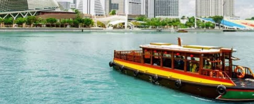 A beautifully lit dhow cruise sailing through Dubai Marina at dusk.