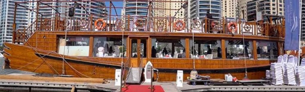 Guests taking photos on the deck of the dhow cruise.