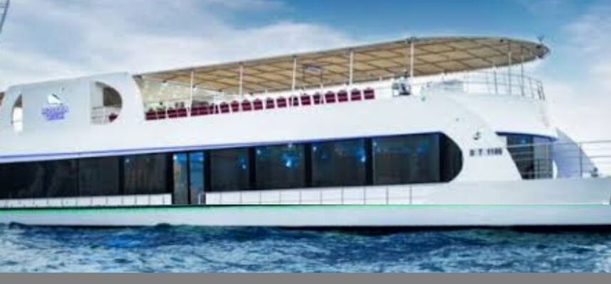 Dhow Dinner Cruise Dubai Marina › Forever Tourism LLC Luxurious dhow at night with vibrant city lights in Dubai Marina.