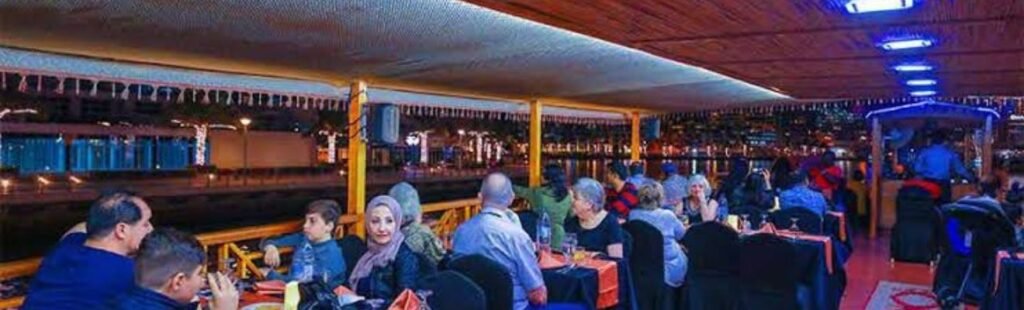 Guests enjoying dessert on the dhow cruise.