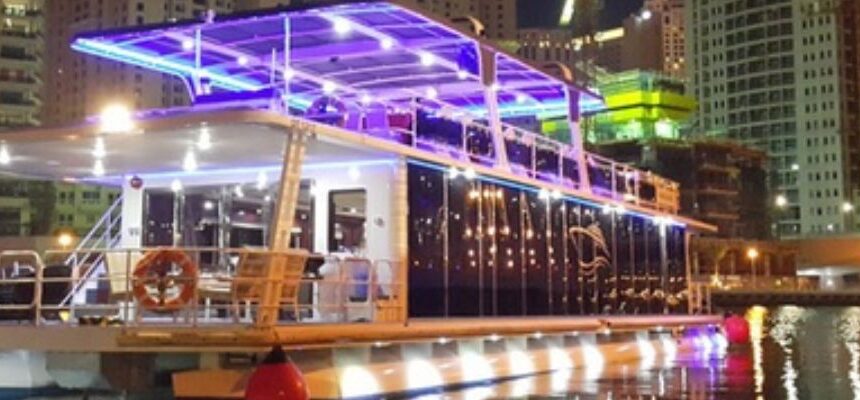 Dhow Cruise Dubai Marina Groupon › Forever Tourism LLC Traditional dhow boat cruising Dubai Marina at twilight.