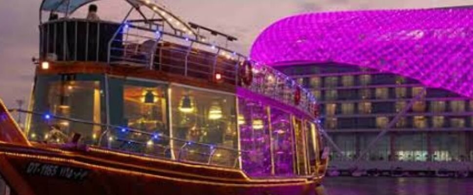 Dhow Cruise gliding through Dubai Marina at twilight.