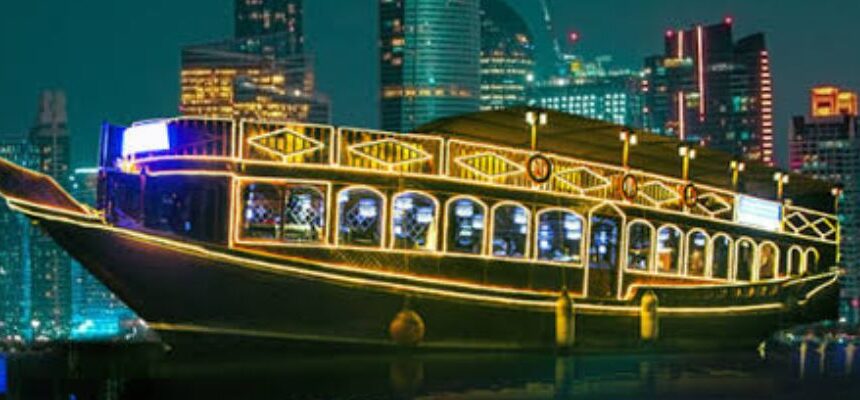 Luxury yacht sailing through Dubai's skyline at sunset.