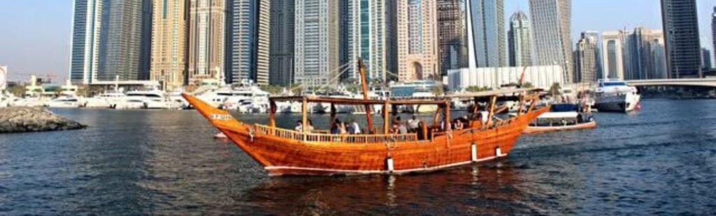 Guests dining on a dhow cruise with views of Dubai Creek.