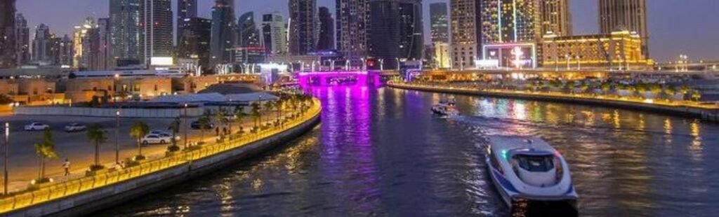 Guests taking photos of the Dubai skyline from the dhow.