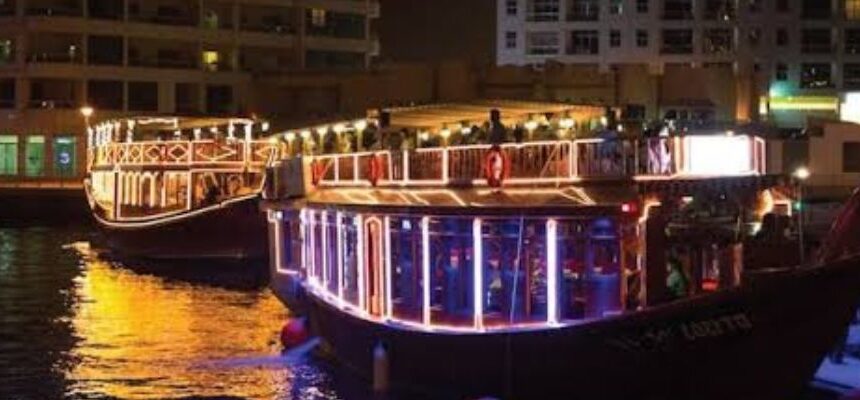 Cheap Dhow Cruise Dinner Dubai › Forever Tourism LLC Traditional dhow boat sailing in Dubai Marina.