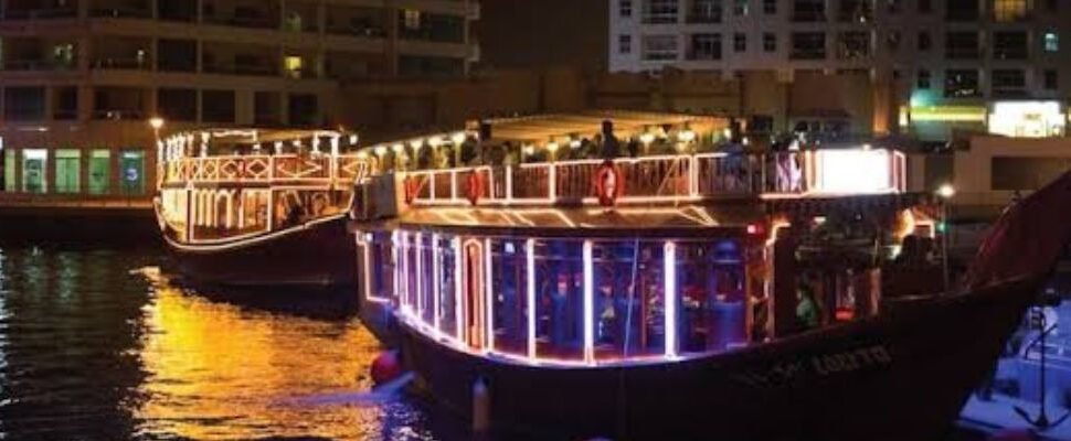 Traditional dhow boat sailing in Dubai Marina.