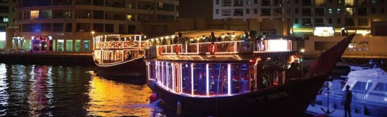 Traditional dhow boat sailing in Dubai Marina.