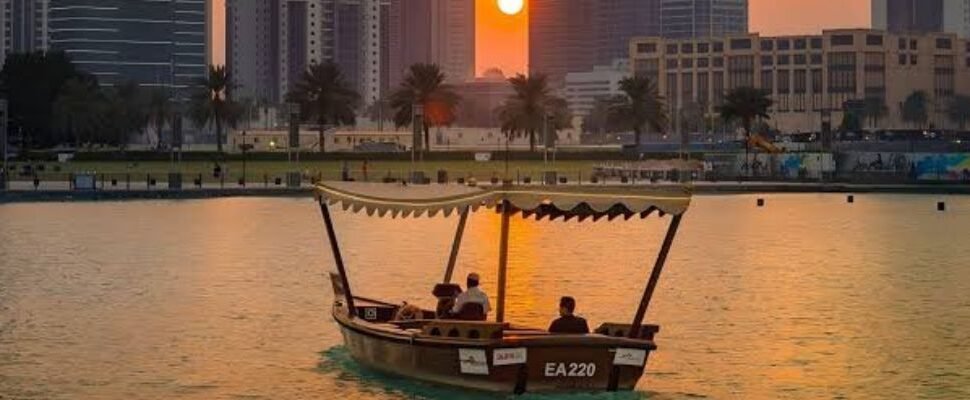 Elegant dhow cruising through Dubai Marina with city skyline in the background.