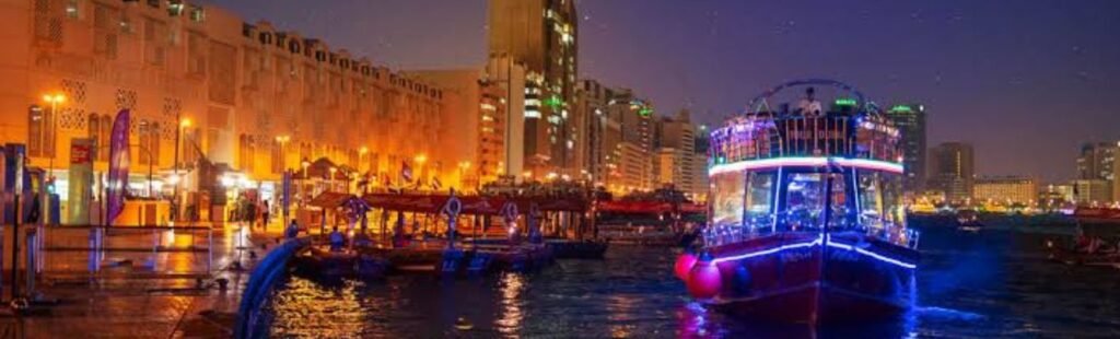 Nighttime view of Dubai's skyline from a cruise.