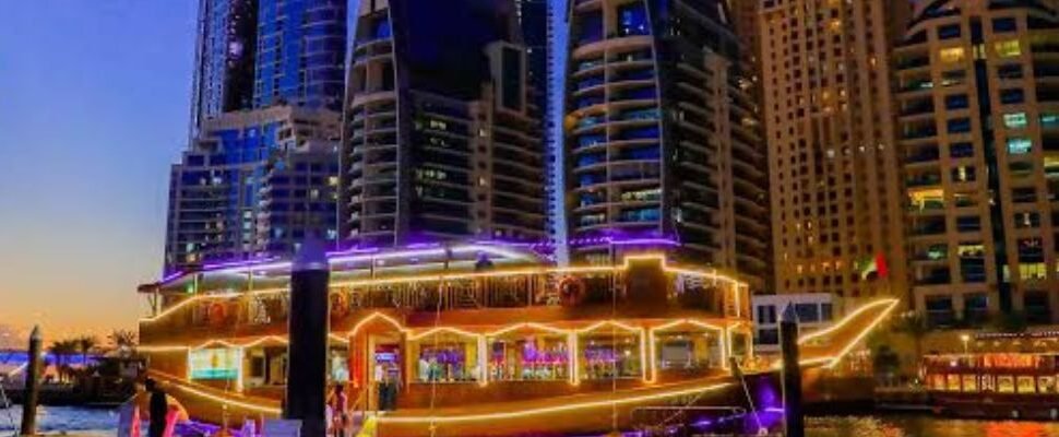 A luxury cruise ship sailing through Dubai Marina.