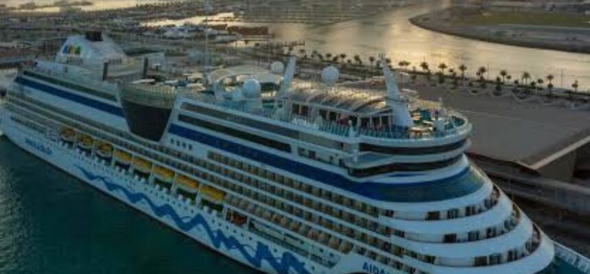 Cruise ship sailing through Dubai Marina at sunset.