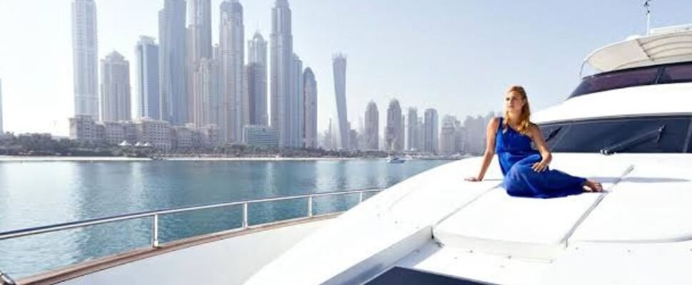 A cruise ship gliding through the calm waters of Dubai Marina.