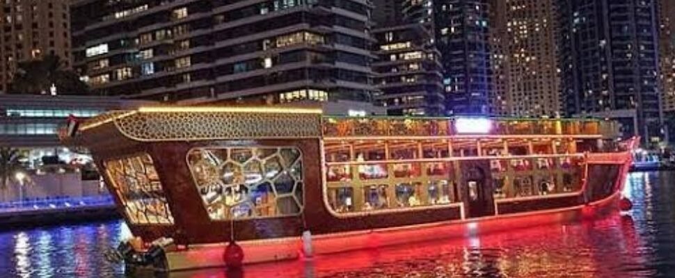 Solo traveler enjoying a serene view of Dubai Marina from the cruise deck.