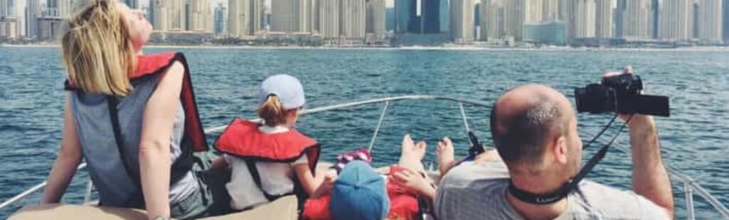 Family taking in the sights on a Dubai river cruise.