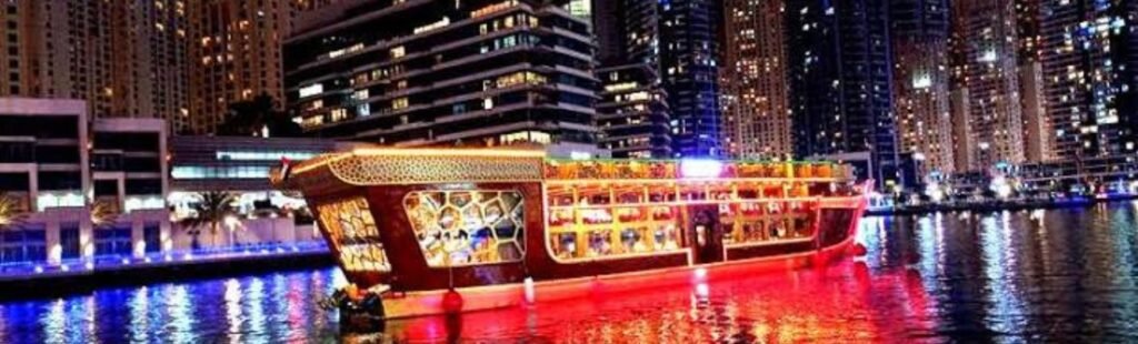 Aerial view of Dubai’s river cruise illuminated at night.