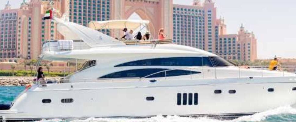 A luxury boat cruising through Dubai Marina at sunrise.