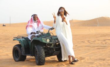 Tourists enjoying a thrilling dune buggy Dubai adventure in the golden desert.