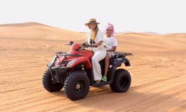 Tourists enjoying quad biking adventure during dubai desert experience