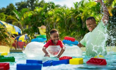 Families enjoying rides at LEGOLAND Water Park with information on LEGOLAND Dubai tickets, timings, and opening hours.
