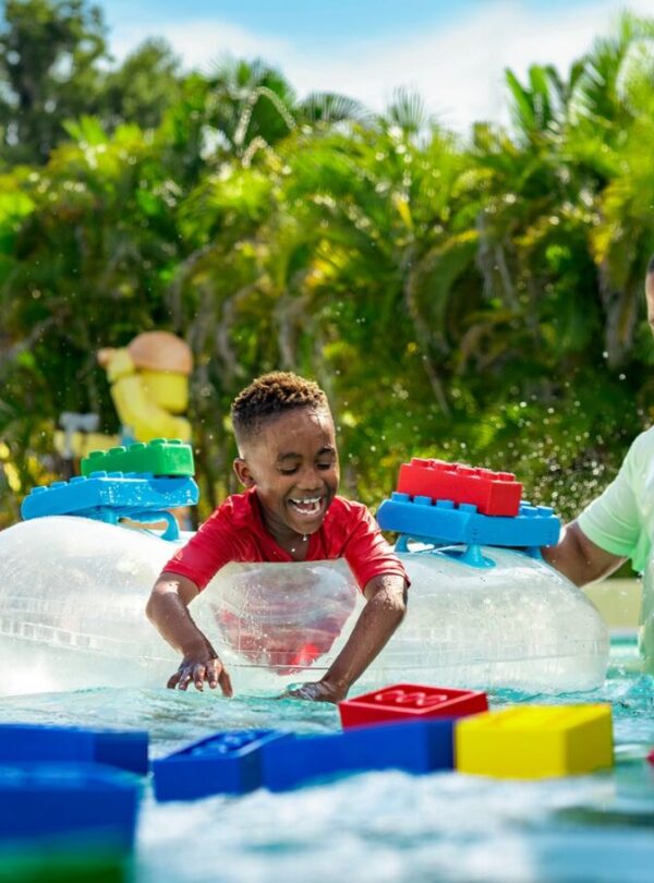 Families enjoying rides at LEGOLAND Water Park with information on LEGOLAND Dubai tickets, timings, and opening hours.