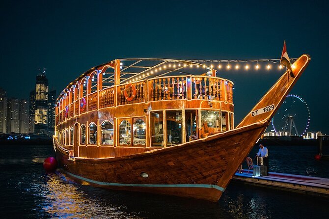 Beautifully lit traditional dhow sailing on Dubai Marina Dhow Cruise, offering a luxurious Marina Dhow Cruise with dinner and stunning city views in Marina Dhow Cruise Dubai.