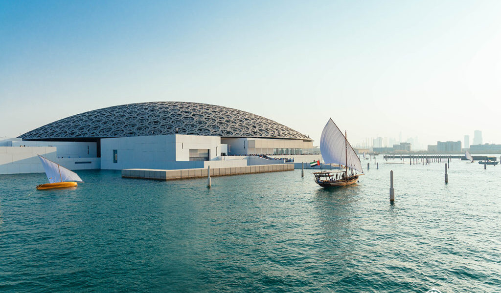 Stunning view of Louvre Abu Dhabi architecture, showcasing the iconic dome and waterfront design. Explore The Louvre Abu Dhabi and book Louvre Abu Dhabi tickets for an unforgettable cultural experience.