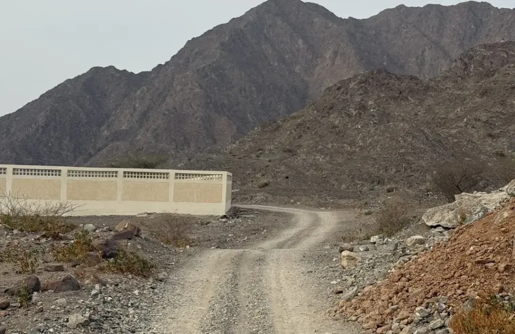 Winding dirt road through rugged mountains, highlighting one of the hidden Gems of Fujairah.
