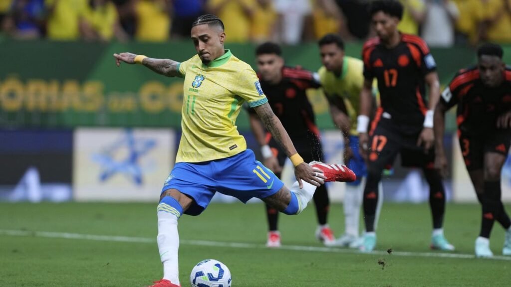 Fans cheering in a packed stadium during the Brazil vs Colombia match, with banners highlighting visa services for UAE residents traveling from Dubai.