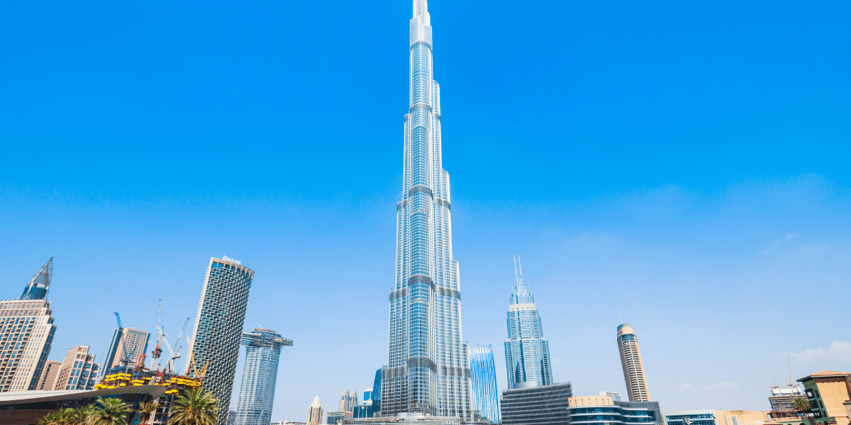 Aerial view from the top Burj Khalifa floors showing Dubai skyline and visitors enjoying the Burj Khalifa experience with pre-booked Burj Khalifa Tickets.