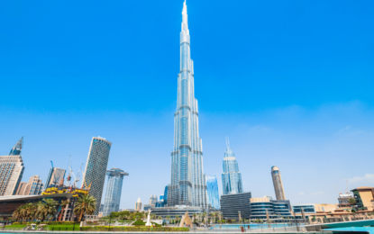 Aerial view from the top Burj Khalifa floors showing Dubai skyline and visitors enjoying the Burj Khalifa experience with pre-booked Burj Khalifa Tickets.