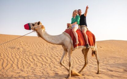 Tourists enjoying Dune Bashing Dubai during an exciting Desert Safari Dubai, with golden sand dunes and exclusive desert safari deals in the backdrop.