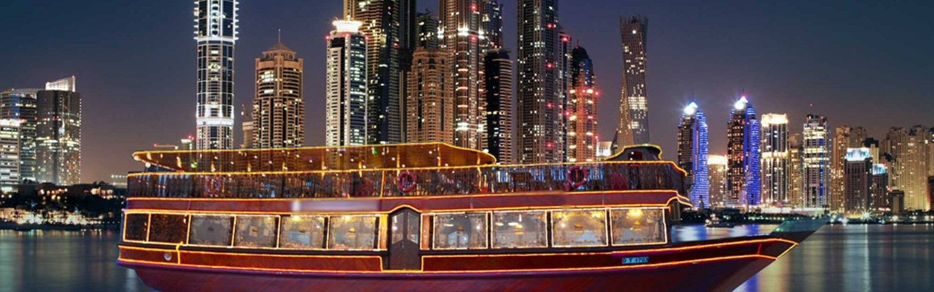 Luxury Dhow Cruise in Dubai Marina offering scenic views, fine dining, and entertainment on a traditional wooden boat.
