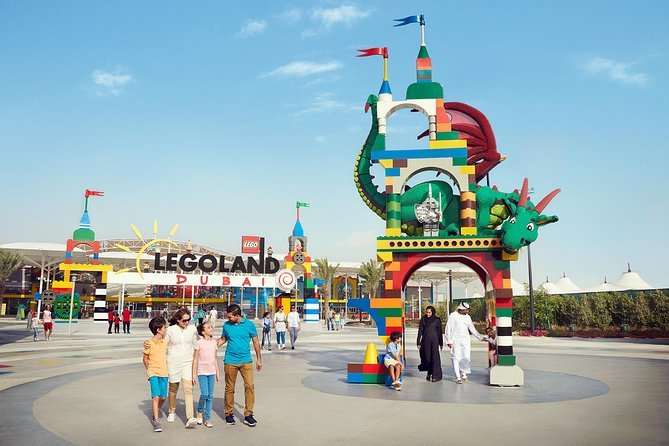 Colorful entrance of Legoland® Dubai theme park with happy families, showing Legoland opening hours, timings, and ticketing information for visitors.