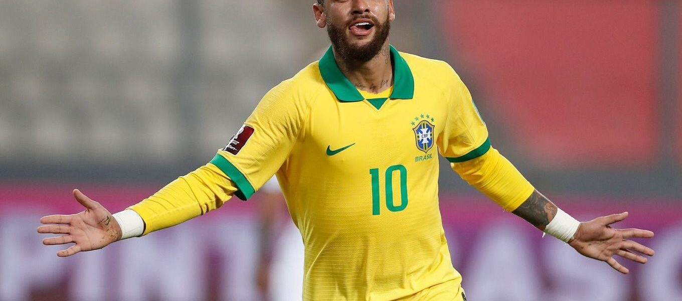 Fans cheering in a packed stadium during the Brazil vs Colombia match, with banners highlighting visa services for UAE residents traveling from Dubai.