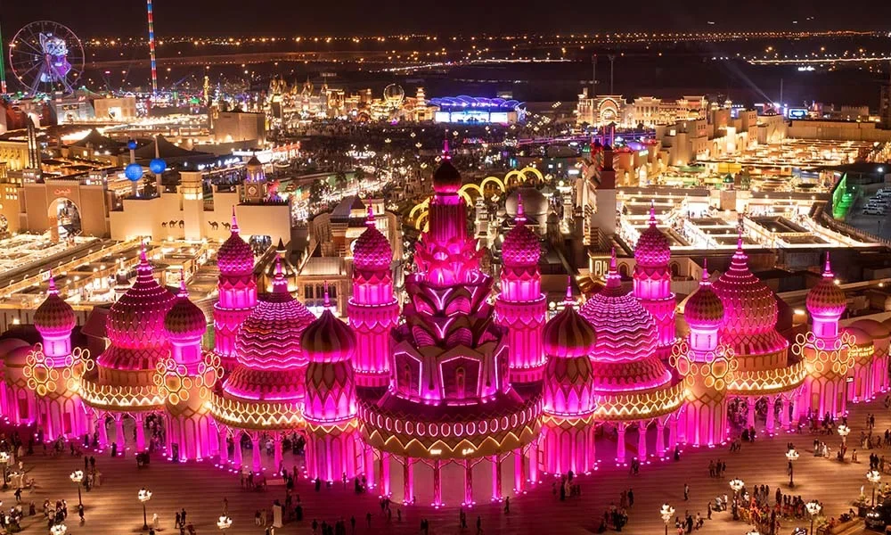 Crowds enjoying cultural pavilions and live shows at Global Village Dubai during peak evening timing.