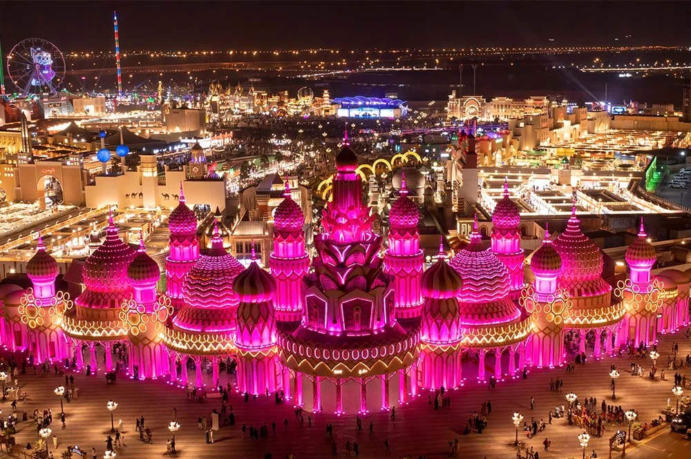 Crowds enjoying cultural pavilions and live shows at Global Village Dubai during peak evening timing.