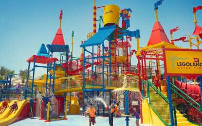 Colorful entrance of Legoland® Dubai theme park with happy families, showing Legoland opening hours, timings, and ticketing information for visitors.