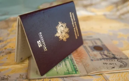 Traveler in Dubai filling Denmark visa application with passport and documents, checking Denmark visa processing time.