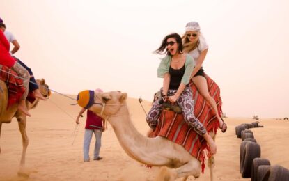 Tourists enjoying dune bashing during the best desert safari in Dubai, with desert safari Dubai booking details and safari timings.