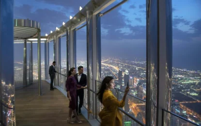 A stunning view of the Burj Khalifa towering over the Dubai skyline during sunset, showcasing its impressive height and architectural design.
