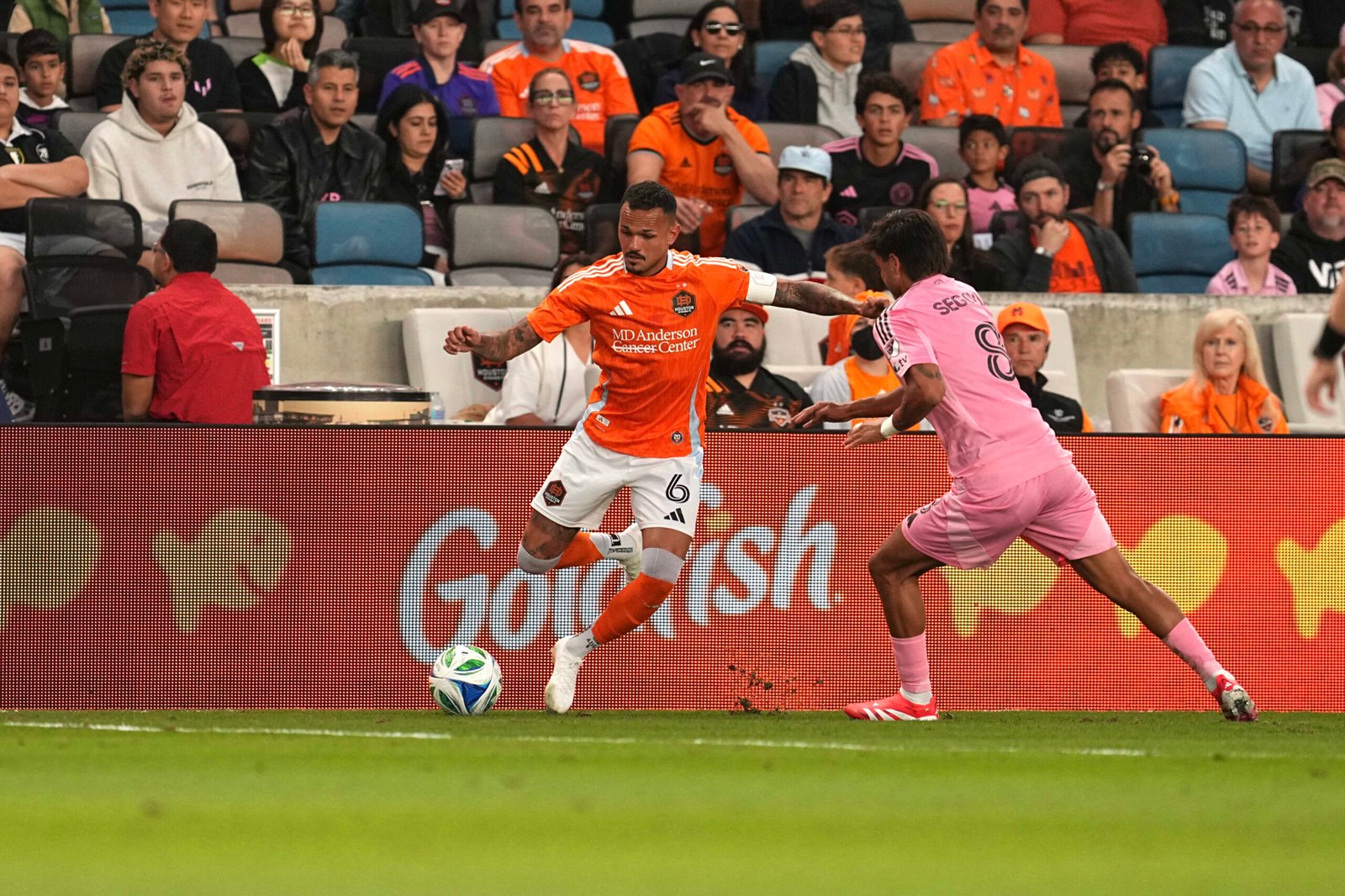 Fans cheering at a packed stadium during an intense Houston Dynamo vs Inter Miami match, showcasing the excitement of Houston Dynamo vs Inter Miami tickets and live-action moments.