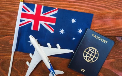 Australian passport, travel documents, and currency on a table, representing the visa policy of Australia and updated Australia visa fees.