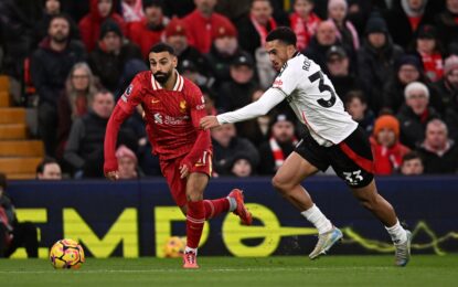 Fans cheering during the Fulham vs Liverpool Premier League match – get your UK visa to witness the next exciting Liverpool match live.