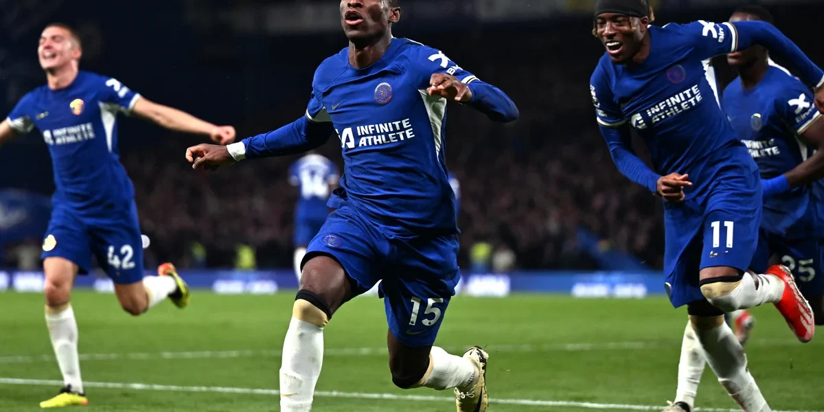 Chelsea vs Tottenham match in action showing players from both teams competing at a packed stadium.