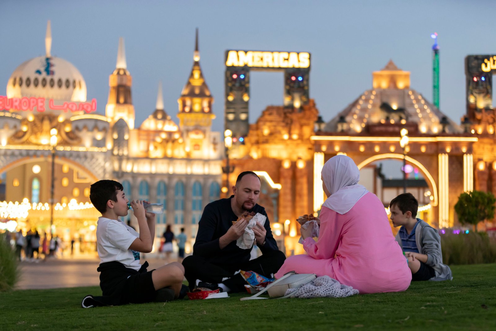 Crowds enjoying cultural shows and food stalls at Global Village before the last date of the season, showcasing Global Village tickets in hand.