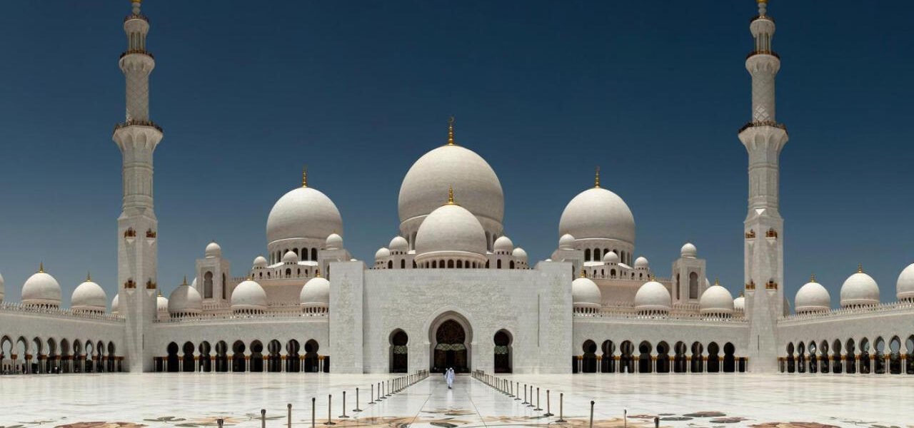 View of Sheikh Zayed Grand Mosque and Ferrari World during a city tour Abu Dhabi, showcasing cultural landmarks and exciting attractions.
