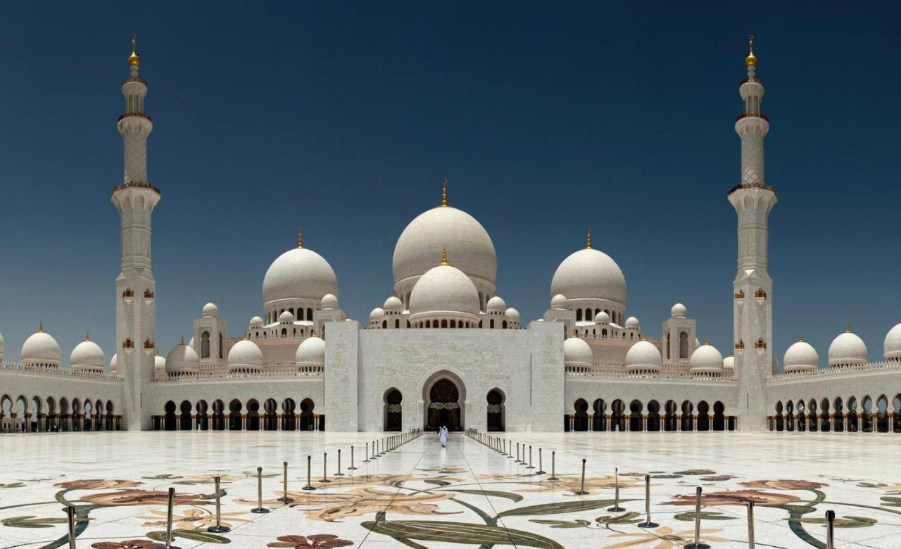 View of Sheikh Zayed Grand Mosque and Ferrari World during a city tour Abu Dhabi, showcasing cultural landmarks and exciting attractions.